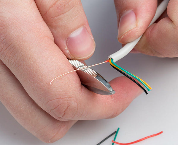 Electrician's Scissors - Back of shears stripping coating from copper wire - Primus Cable