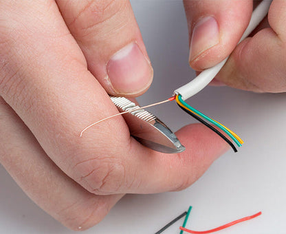 Electrician's Scissors - Back of shears stripping coating from copper wire - Primus Cable